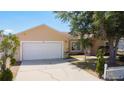 Charming home with two-car garage, mature trees and a classic picket fence enhances the curb appeal at 310 Cornwallis Ct, Kissimmee, FL 34758