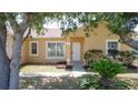 Home featuring front entrance framed by mature trees and tropical landscaping at 310 Cornwallis Ct, Kissimmee, FL 34758