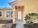 Inviting front porch with white door and decorative columns at 310 Cornwallis Ct, Kissimmee, FL 34758