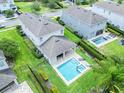 Aerial view of the backyard with a pool and patio area, surrounded by well-maintained landscaping at 311 W Falls Dr, Kissimmee, FL 34747