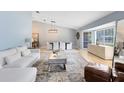 Bright living room featuring vaulted ceilings, neutral tones, stylish furnishings, and abundant natural light at 3285 Majestic Oak Dr, St Cloud, FL 34771