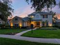 Charming two-story home with a landscaped front yard, illuminated walkway and welcoming double-door entrance at 3352 Park Grove Ct, Longwood, FL 32779