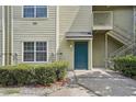 Close-up of a unit entrance with blue door, stairway, and small front garden at 3721 S Lake Orlando Pkwy # 05, Orlando, FL 32808