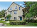 Two-story condo building featuring a light green exterior, symmetrical windows, and landscaped grounds at 3721 S Lake Orlando Pkwy # 05, Orlando, FL 32808