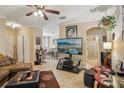 Inviting living room features tile floors, a ceiling fan, and a wall mounted entertainment center at 3721 S Lake Orlando Pkwy # 05, Orlando, FL 32808