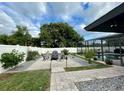 A serene backyard features a gravel patio with outdoor seating and lush landscaping at 4297 Abaco Dr, Tavares, FL 32778