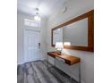 Inviting entryway featuring wood-look flooring, accent table, and a stylish light fixture at 4807 Kings Castle Cir, Kissimmee, FL 34746