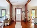 Elegant entryway with hardwood floors, decorative wallpaper, and beautiful millwork at 511 E Mirror Lake Dr, Fruitland Park, FL 34731