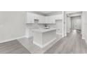 Modern kitchen featuring white cabinets, an island, and updated countertops at 5438 Brownell St, Orlando, FL 32810