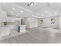 Open-concept living room and kitchen area with recessed lighting and wood flooring at 5438 Brownell St, Orlando, FL 32810