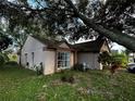 Side view of a single-story house featuring a large window and nicely manicured landscaping at 567 Queensbridge Dr, Lake Mary, FL 32746