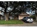 Inviting single-story home with a two-car garage and mature trees shading the front yard at 567 Queensbridge Dr, Lake Mary, FL 32746