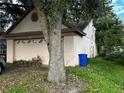 Single-story home with a two-car garage and mature trees surrounding the property at 567 Queensbridge Dr, Lake Mary, FL 32746
