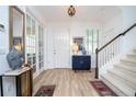 Bright entryway featuring wood-look floors, a staircase, and decorative accents at 6543 Orange Cream Aly, Winter Garden, FL 34787