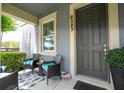 Inviting front porch with comfortable seating, a welcome sign, and a view of the outdoors at 6543 Orange Cream Aly, Winter Garden, FL 34787