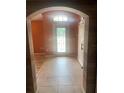 Welcoming foyer with decorative door, tiled floor, and barn door detail offering a bright entryway at 701 Twin Lake Ave, Deltona, FL 32738