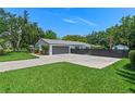 Well-maintained property featuring a two-car garage, private fencing, and ample parking space at 711 Valencia Ct, Winter Garden, FL 34787