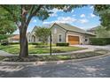 A beautiful home with a green tile roof, lush landscaping, and an attached garage, showing great curb appeal at 7698 Mount Carmel Dr, Orlando, FL 32835