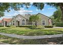 Beautiful exterior view of a well-kept single-story home with a green tiled roof and manicured front yard at 7698 Mount Carmel Dr, Orlando, FL 32835