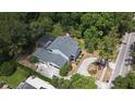 An aerial view showcasing the backyard pool, lush greenery, and the home's expansive driveway at 830 Miami Springs Dr, Longwood, FL 32779