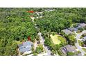 An aerial view of a home with pool, surrounded by lush greenery and neighborhood amenities at 830 Miami Springs Dr, Longwood, FL 32779