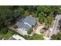 Stunning aerial view of a house with a pool, surrounded by lush greenery and a circular driveway at 830 Miami Springs Dr, Longwood, FL 32779