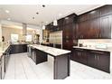 Spacious kitchen featuring custom cabinets, granite countertops, stainless steel appliances, and ample storage at 830 Miami Springs Dr, Longwood, FL 32779