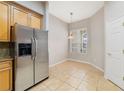 A bright dining space adjacent to the kitchen with tile flooring and a window at 8414 Frescada Ct, Orlando, FL 32836