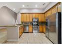 Bright kitchen featuring stainless steel appliances, granite countertops, and ample cabinet space at 8414 Frescada Ct, Orlando, FL 32836