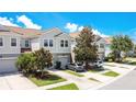 A beautiful exterior view of townhomes with well-manicured lawns and private parking spaces at 9069 Shepton St, Orlando, FL 32825