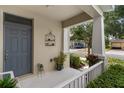 Welcoming front porch featuring neutral tones, stylish decor, and a peek into a quiet neighborhood street at 976 Eagle Bay St, Winter Springs, FL 32708