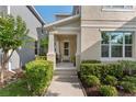Inviting front porch with traditional design, featuring well-manicured bushes and a comfortable seating area at 976 Eagle Bay St, Winter Springs, FL 32708