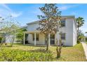 Spacious backyard featuring a covered patio and lush greenery, perfect for outdoor entertaining and relaxation at 9836 Old Patina Way, Orlando, FL 32832