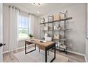 Bright home office with a large window, modern desk, and shelving at 10234 Hadley St, Orlando, FL 32829