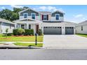Charming two-story home features a three car garage and beautifully landscaped front yard at 10249 Spring Lake Dr, Clermont, FL 34711