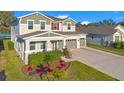 Attractive home exterior featuring a well-kept lawn and driveway leading to an attached two-car garage at 10249 Spring Lake Dr, Clermont, FL 34711