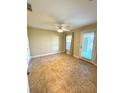Bright and airy bedroom featuring neutral walls, tiled floors, a ceiling fan, and a glass door to the outside at 10506 Green Ivy Lane, Orlando, FL 32832