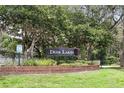 Image of the Deer Lakes community entrance sign framed by mature trees and greenery at 10664 Spring Buck Trl, Orlando, FL 32825
