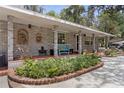 Inviting brick home with covered porch, well-maintained landscaping, and ample parking space at 1090 Braddock Rd, Deltona, FL 32725