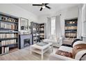 Cozy living room with bookshelves, a fireplace, natural light, and comfortable seating for relaxation at 1101 Rush Ct, Celebration, FL 34747