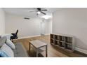 Bright living room featuring hardwood floors, a ceiling fan and neutral wall paint at 1140 S Orlando Ave # E11, Maitland, FL 32751