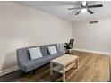 Cozy living room featuring hardwood floors, a ceiling fan and neutral wall paint at 1140 S Orlando Ave # E11, Maitland, FL 32751