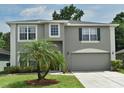 Inviting two-story home showcasing a well-manicured lawn and attached two-car garage at 115 Bristol Forest Trl, Sanford, FL 32771