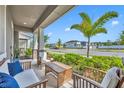 Relaxing front porch with comfortable seating and views of a beautifully landscaped neighborhood street at 11574 Buoy Point Pl, Orlando, FL 32832