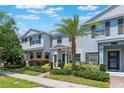 Charming townhouse with a well-manicured lawn, walkway, and attractive landscaping on a sunny day at 11631 Mystery Ln, Orlando, FL 32832