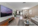 Inviting living room boasts tile floors, a large screen tv, and an open floor plan to the dining and kitchen areas at 11631 Mystery Ln, Orlando, FL 32832