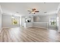 Open-concept living area with wood floors, neutral paint, and a ceiling fan at 124 Mcleods Way, Winter Springs, FL 32708