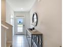 Elegant entryway featuring a console table with a mirror, offering a welcoming ambiance at 1300 Isleta Loop, Kissimmee, FL 34741