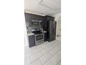 Modern kitchen features stainless steel appliances and dark cabinets at 1321 Carey Glen Cir, Orlando, FL 32824
