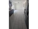 Bright kitchen featuring tile floors, stainless steel appliances and dark cabinets at 1321 Carey Glen Cir, Orlando, FL 32824